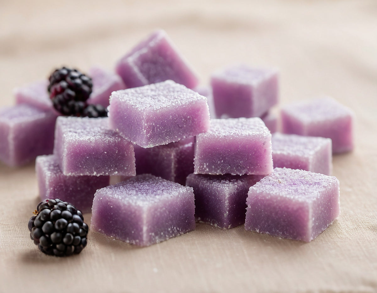 Close-up of lavender sugar-coated even recovery gummies with blackberries